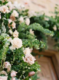 Close-up of blush garden roses and florals from ceremony arch at Sunstone Winery wedding.