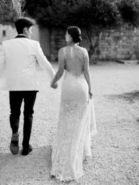 Bride and groom walking together toward ceremony at Sunstone Winery vineyard wedding.