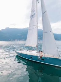 Bride and groom seated on sailboat deck after Lake Como destination wedding