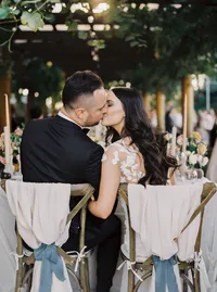 Bride and groom sharing a kiss during the reception celebration at their romantic Lake Oswego Oregon winery wedding.