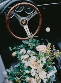 Detail of blush roses, white ranunculus, and dusty miller in a garden-style bouquet, from a Santa Barbara wedding editorial by Yuliya Supin Design