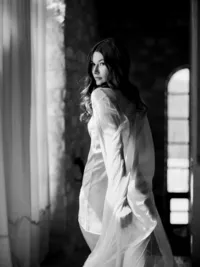 Bride walking in silk robe during wedding morning preparations at Sunstone Winery in Santa Ynez Valley.