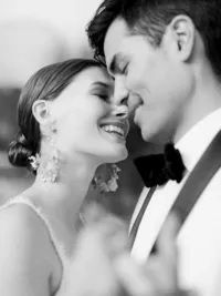 Bride and groom laughing with foreheads touching during romantic Sunstone Winery wedding in Santa Ynez Valley