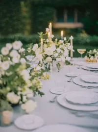 Reception table set with white roses, scalloped china, and gold flatware, styled for a Santa Barbara wedding editorial by Yuliya Supin Design