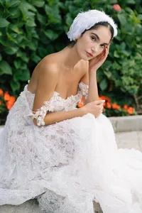 Model seated in calm pose wearing minimal bridal look during Lake Como editorial