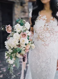 Bride holding a romantic bouquet of Cocoa Loco roses, blush garden roses, and burgundy accents during an elegant winery wedding in Lake Oswego, Oregon.