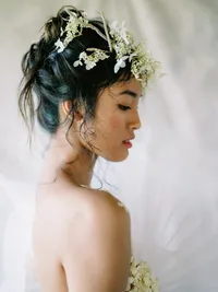 Bridal portrait with delicate floral headpiece in soft editorial lighting