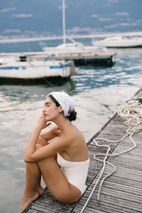 Bride with soft hand gesture and eyes closed wearing minimal styling captured at Lake Como