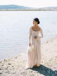 Full-length bridal editorial portrait by water in Olympic National Park natural setting