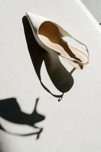 Artistic bridal shoe detail captured with dramatic hillside shadows during bridal morning.