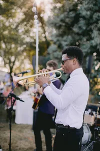 Musicians playing saxophone and guitar during the reception celebration at a romantic winery wedding in Lake Oswego Oregon.