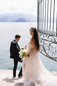 American couple portrait overlooking Lake Como at historic villa gates