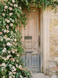 Ceremony arch decorated with blush garden roses and tulips at Sunstone Winery wedding.