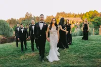 Bridal party walking through the garden toward the ceremony during an elegant winery wedding in Lake Oswego Oregon.