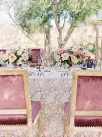 Elegant reception table with blush florals and velvet chairs at Sunstone Winery wedding.