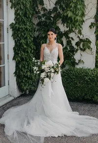 Bride holding lush garden rose bouquet at private estate wedding in Vancouver, Washington.