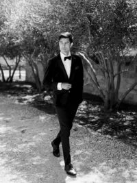 Groom portrait wearing black tuxedo at Sunstone Winery wedding in Santa Ynez Valley.