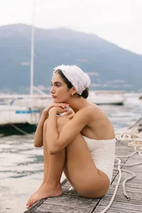 Close portrait of model leaning forward in soft bridal styling photographed at Lake Como
