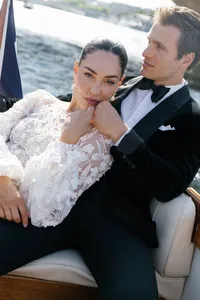 Editorial portrait of the bride resting against the groom on the boat