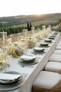 Luxury reception table extending toward rolling Oregon hills at sunset.