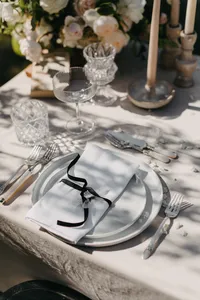 Reception table detail with black ribbon and ivory linen at private estate wedding in Vancouver, Washington.