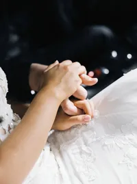 Close-up detail of bride and groom holding hands during their romantic Lake Oswego Oregon winery wedding celebration.