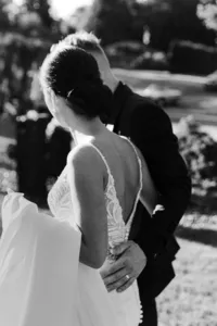 Bride and groom walking through estate garden at private wedding in Vancouver, Washington.