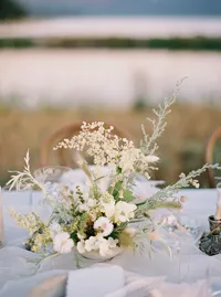 Light and airy floral arrangement with neutral tones for wedding table design