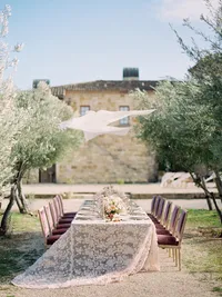 Reception table overlooking vineyards and olive trees at Sunstone Winery in Santa Ynez.