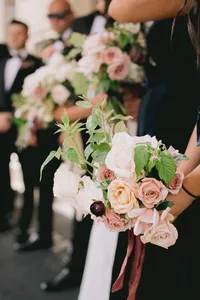 Bridesmaid bouquet with Cocoa Loco roses, Quicksand roses, burgundy ranunculus, silk ribbon, and raspberry foliage during a romantic winery wedding in Lake Oswego Oregon.