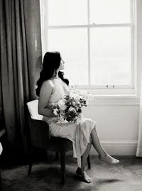 Black and white portrait of the bride getting ready with her bouquet in the bridal suite before her Lake Oswego Oregon winery wedding.