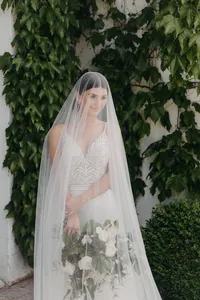 Bride standing against ivy-covered estate home during modern romantic wedding in Brush Prairie, Washington.