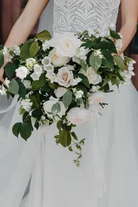 Bride holding blush and white garden rose bouquet at private estate wedding in Vancouver, Washington.
