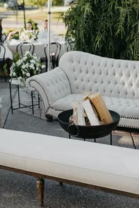 Outdoor lounge with velvet sofa and fire pit at private estate wedding reception in Vancouver, Washington.