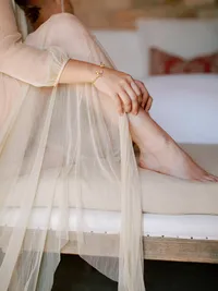 Close-up of bride’s silk robe and bridal preparation details during wedding morning at Sunstone Winery.