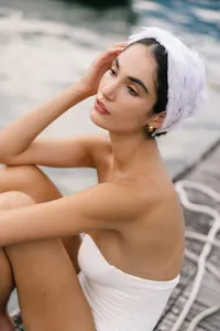 Close portrait of model wearing feather headpiece, bridal styling captured for Lake Como editorial