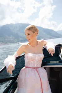 Bride in a blush gown on the water, Lake Como in the background