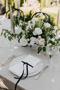 Ivory velvet linen tablescape with black ribbon detail at private estate wedding in Vancouver, Washington.