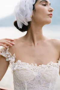 Bride with soft hand gesture wearing minimal bridal styling captured at Lake Como