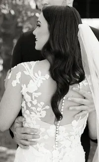 Black and white portrait of groom embracing the bride from behind during a romantic Lake Oswego Oregon winery wedding.