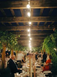 Evening wedding reception with glowing lights and dancing guests celebrating a romantic Lake Oswego Oregon winery wedding.