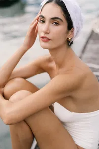 Close portrait of model in minimal bridal styling with white headpiece captured in Lake Como editorial