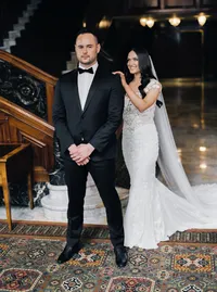 Bride gently touching the groom’s shoulder during their emotional first look moment at the Nines Hotel in Portland before their Oregon winery wedding.