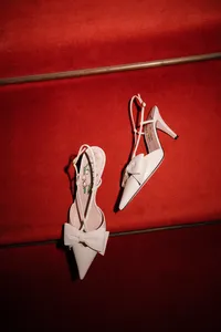 Red high heels styled against a bold red stairs