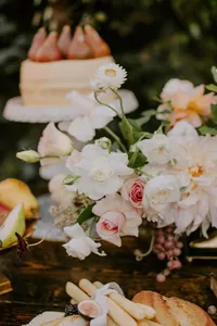 floral arrangement with grapes and wedding cake