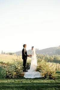 Outdoor wedding ceremony altar overlooking a vineyard