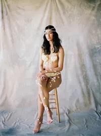 Seated bridal portrait with minimal styling and soft textures