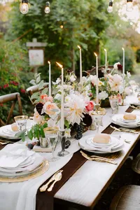 Wedding table detail with bread, fruit, and cheese arranged for outdoor reception