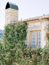 Balcony architecture of Sunstone Winery surrounded by climbing greenery in Santa Ynez Valley.