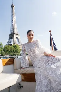 Bridal portrait taken from a boat on the Seine River with the Eiffel Tower visible in the background.